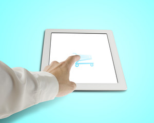 Hand touching shopping cart icon on tablet