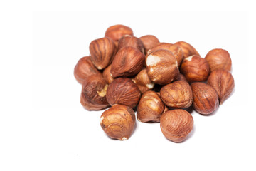 Brown hazelnuts against white background