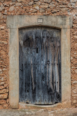Old wooden door in stone wall
