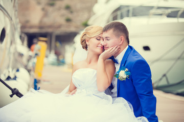 Beautiful bride and groom wedding couple near sea yacht
