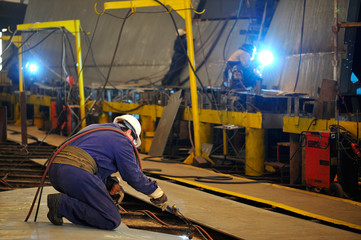 a welder working at shipyard in day time
