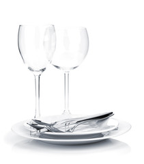 Silverware or flatware on plates and wine glasses