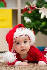 funny baby dressed in Santa Claus hat
