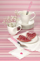 Valentine's Day red pancakes in heart shape with sour cream