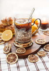 Black tea with lemon in the silver glass-holder