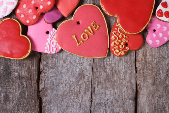 Many different hearts valentines cookies on old wooden table