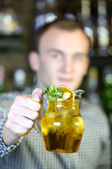 young man working as a bartender in a nightclub bar