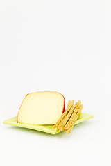 Cheese and breadsticks on square plate
