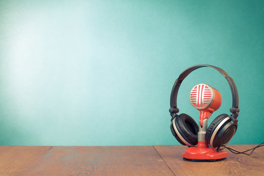 Retro red microphone and headphones front mint green background