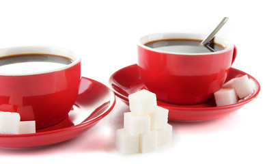 Red cups of strong coffee and sugar close up