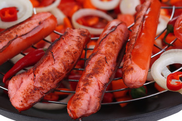 Delicious sausages in wok close-up background