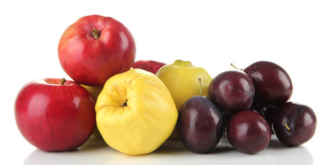 Quinces with apples and plums isolated on white