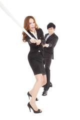 business people playing tug of  war