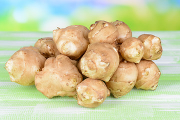 Topinambur roots on table on light background