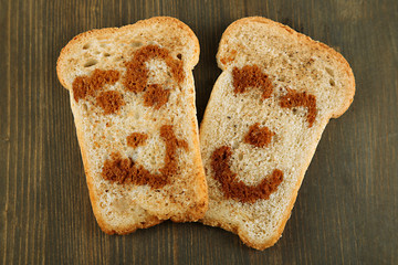 Funny toasts, on wooden background