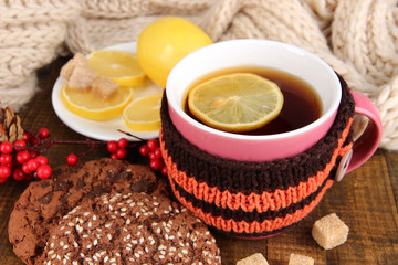 Cup of tea with lemon on wooden table