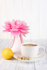Fototapeta na wymiar Cup of tea with lemon close up