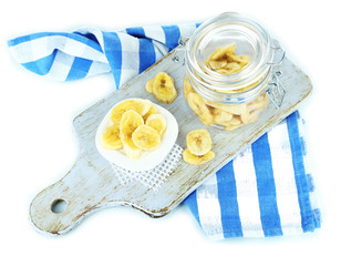 Fresh and dried banana slices in glass jar,