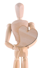 Wooden mannequin holding heart isolated on white
