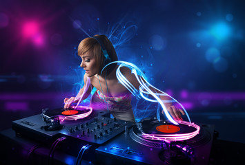 Disc jockey playing music with electro light effects and lights