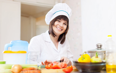   female cook in toque with vegetables