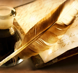 Old book with feather