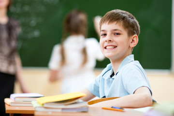 School boy in classroom at lesson