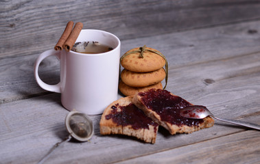 Mug of tea and jam for breakfast