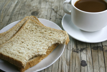 plate with a cup of coffee and bread