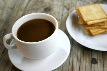 plate with a cup of coffee and cookies