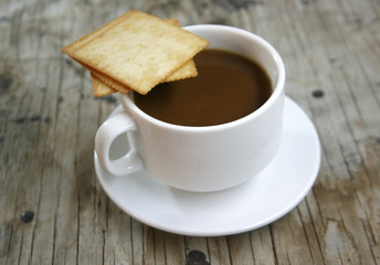 plate with a cup of coffee and cookies