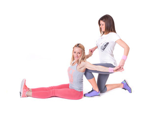 Fototapeta na wymiar Two young women doing yoga stretching exercises