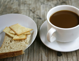 plate with a cup of coffee and bread