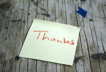 paper note on wooden  background