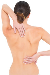 Naklejka premium Rear view of a fit topless young woman with back pain