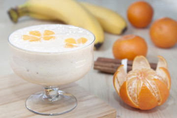 Cocktail of banana with mandarins and yogurt.