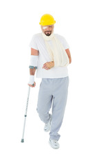 Man in hard hat with broken hand and crutch