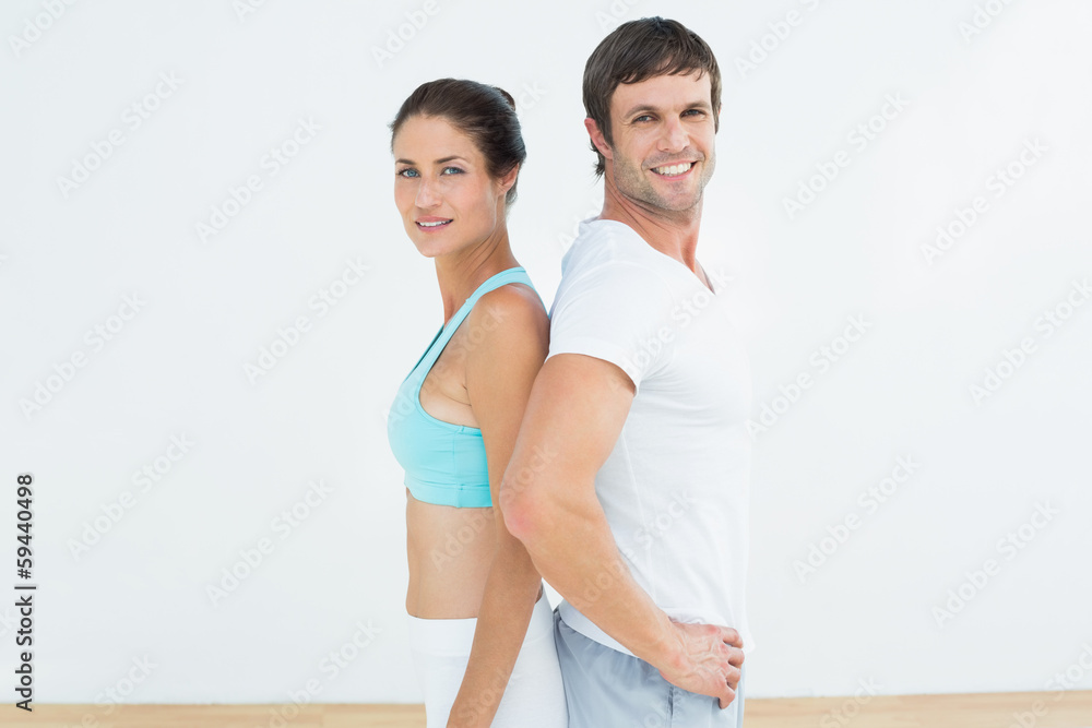 Wall mural portrait of a fit couple in fitness studio