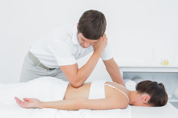 Male physiotherapist massaging woman's back