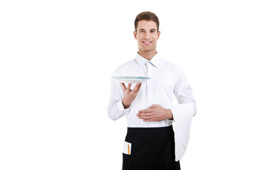 Professional waiter holding an empty dish. Isolated on white