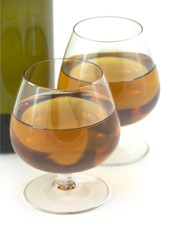 Glasses with dessert grape wine and a bottle isolated closeup