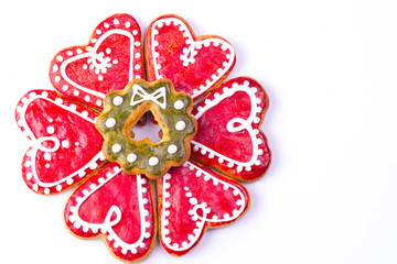 Gingerbread cookies and spices over white background close up