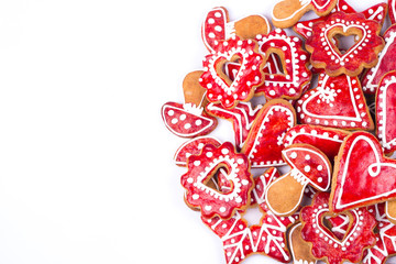 Gingerbread cookies and spices over white background close up
