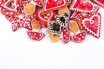 Gingerbread cookies and spices over white background close up