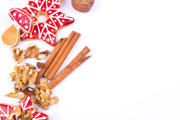 Gingerbread cookies and spices over white background close up