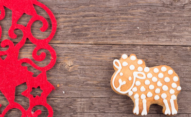 Gingerbread cookies hanging over wooden background