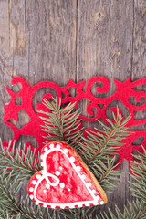 Gingerbread cookies hanging over wooden background