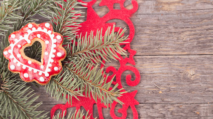 Gingerbread cookies hanging over wooden background