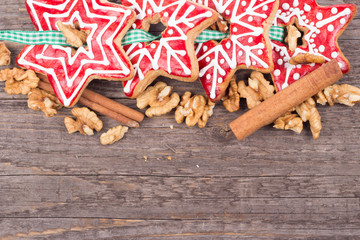 Gingerbread cookies hanging over wooden background