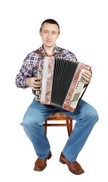 Man plays harmonica sitting on a chair